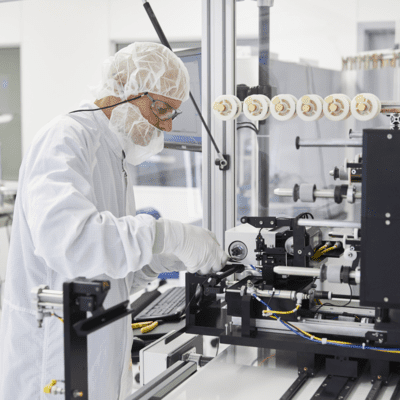 a person in a white suit working on a machine