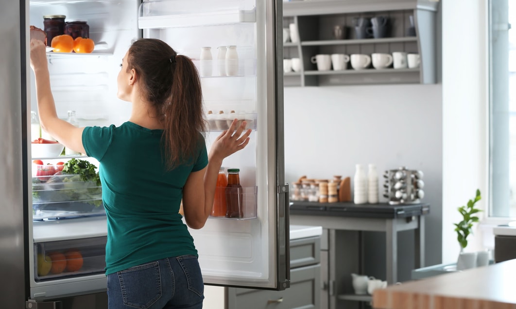 a person looking at a refrigerator
