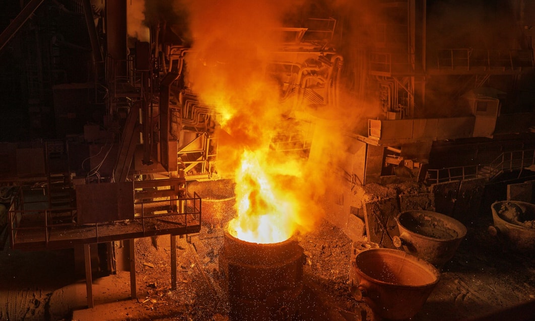 en stor metallhink med eld och rök