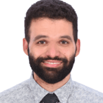 en person med skägg och mustasch som bär slips