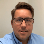 a person wearing glasses and a blue shirt