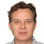 en person med brunt hår som bär en rutig skjorta