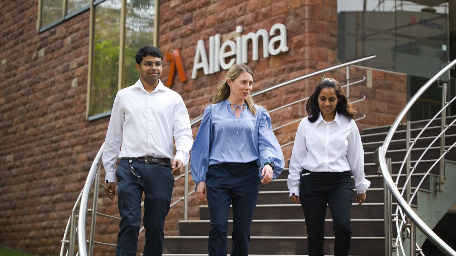 a group of people walking up stairs outside a building