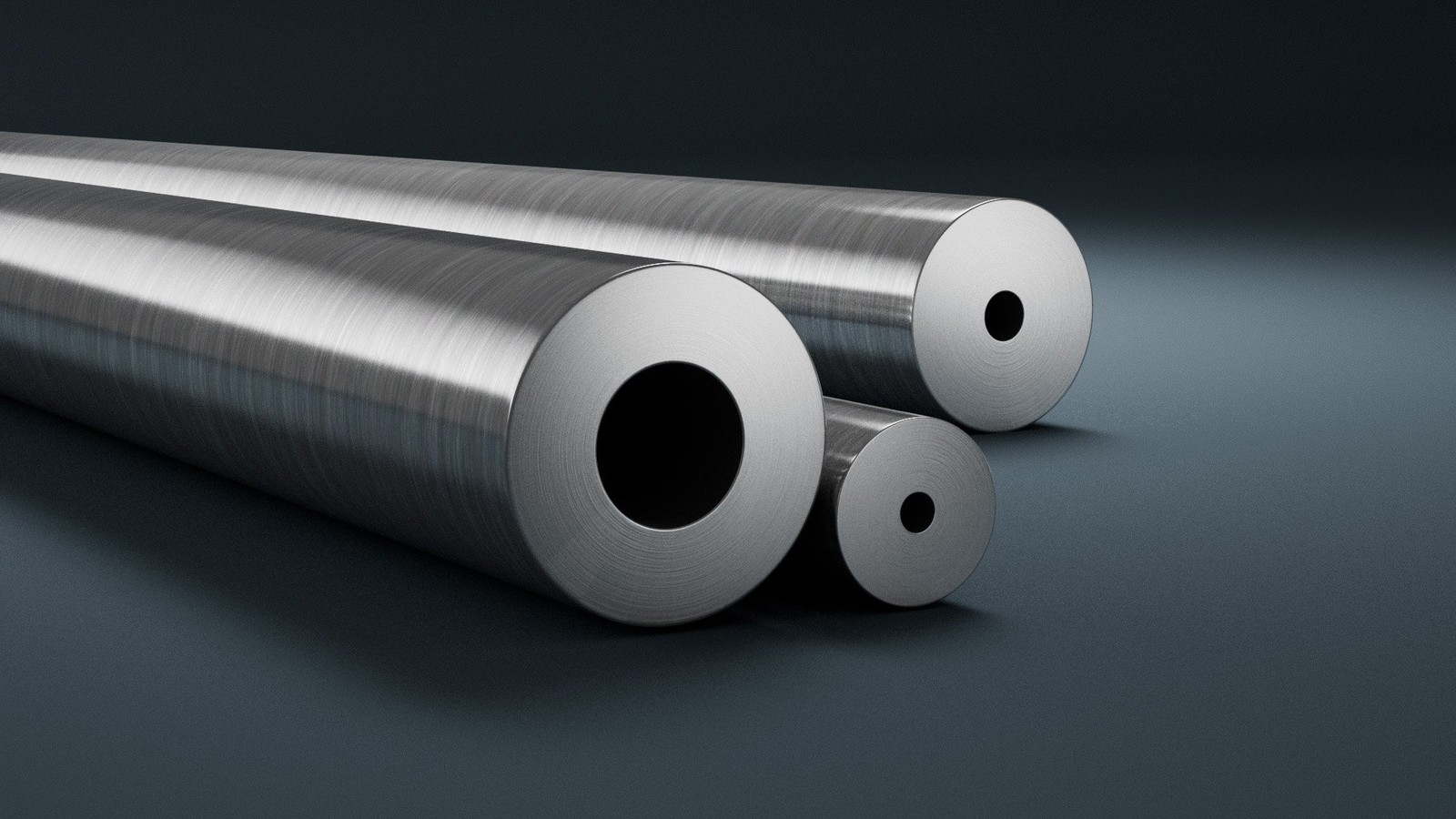 several metal tubes on a grey surface