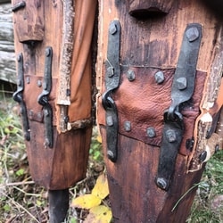 a pair of wooden poles with metal hinges