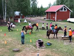 a group of people riding horses in a field