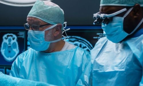 a group of surgeons in a operating room