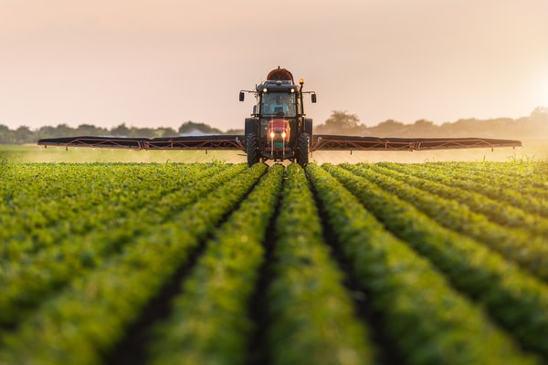 a tractor spraying a field