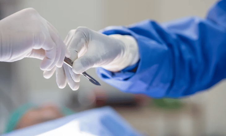 a person holding a scalpel