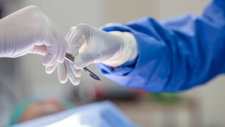 a person holding a scalpel