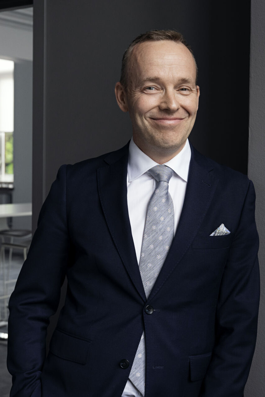 a person in a suit smiling