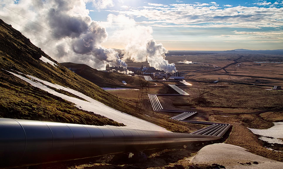 a pipe on a hill with smoke coming out of it